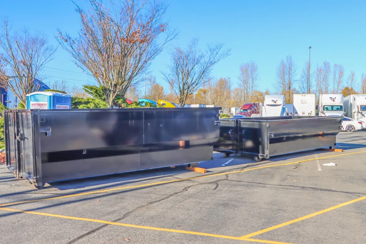 Professional dumpster rental service with roll-off container on residential driveway in Mountain View